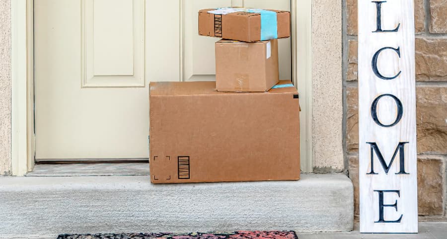 Boxes by the door of a residence with a welcome sign in Mobile